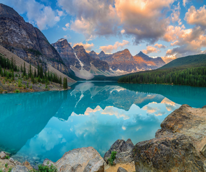 a body of water with a mountain in the background moraine lake